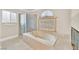 Relaxing main bathroom with a soaking tub, separate shower, and privacy window at 3367 Trickling Stream Cir, Las Vegas, NV 89117