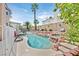 Inviting backyard pool and spa area surrounded by lush landscaping and lounge seating at 3367 Trickling Stream Cir, Las Vegas, NV 89117