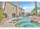 Backyard pool and spa feature rock accents, mature landscaping, and privacy fencing at 3367 Trickling Stream Cir, Las Vegas, NV 89117