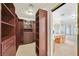 Spacious walk-in closet with custom shelving and storage, adjacent to the primary bathroom at 3367 Trickling Stream Cir, Las Vegas, NV 89117