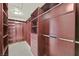 Spacious walk-in closet with custom shelving, drawers, and ample hanging space for organized storage at 3367 Trickling Stream Cir, Las Vegas, NV 89117