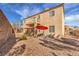 View of backyard with patio, desert landscaping, and second story balcony at 3401 Bedfordshire Pl, Las Vegas, NV 89129