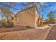 A spacious backyard with patio, desert landscaping, and second story balcony at 3401 Bedfordshire Pl, Las Vegas, NV 89129