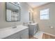 Bright bathroom featuring dual sinks, modern fixtures and mirror at 3401 Bedfordshire Pl, Las Vegas, NV 89129