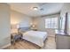 Comfortable bedroom with neutral tones, laminate floors, and ample natural light at 3401 Bedfordshire Pl, Las Vegas, NV 89129