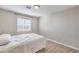 Cozy bedroom with neutral tones, laminate floors, and ample natural light at 3401 Bedfordshire Pl, Las Vegas, NV 89129