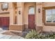 Exterior columns flank the entry door with decorative sconces and minimal desert landscaping at 3401 Bedfordshire Pl, Las Vegas, NV 89129