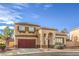 Front exterior of a two-story home featuring a red garage door, desert landscaping, and an arched entryway at 3401 Bedfordshire Pl, Las Vegas, NV 89129