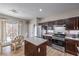 The kitchen provides stainless steel appliances, dark cabinetry, a center island and a casual dining area at 3401 Bedfordshire Pl, Las Vegas, NV 89129