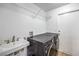 Functional laundry room with sink and a modern, front-load washer and dryer at 3401 Bedfordshire Pl, Las Vegas, NV 89129