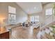 Light-filled living room with soaring ceilings, wood-look floors, and stairs at 3401 Bedfordshire Pl, Las Vegas, NV 89129