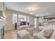 This living room has lots of windows, neutral colored decor, fireplace and access to kitchen and dining at 3401 Bedfordshire Pl, Las Vegas, NV 89129
