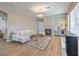 Cozy living room with a herringbone-tiled fireplace, modern lighting, and neutral decor at 3401 Bedfordshire Pl, Las Vegas, NV 89129