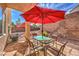 Covered patio with outdoor dining under shade umbrellas at 3401 Bedfordshire Pl, Las Vegas, NV 89129