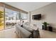 Bright living room with city views, stylish furnishings, and entertainment center at 3726 Las Vegas Blvd # 303, Las Vegas, NV 89158