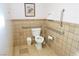 Neutral tile bathroom featuring accessibility grab bars around the toilet for easy access at 3780 E Kellogg Rd, Pahrump, NV 89061