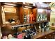A wooden display cabinet featuring artistic wine bottles and jewelry showcasing the property's unique character and decor at 3780 E Kellogg Rd, Pahrump, NV 89061