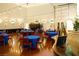 Spacious event space featuring tables with blue tablecloths and string lights for a festive atmosphere at 3780 E Kellogg Rd, Pahrump, NV 89061
