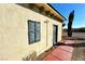 Building with rustic design, highlighted by a dark door, window shutters, and mature landscaping around the entrance at 3780 E Kellogg Rd, Pahrump, NV 89061