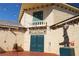 Charming Sanders Winery entrance with double doors, exterior lighting, and a quaint statue at 3780 E Kellogg Rd, Pahrump, NV 89061