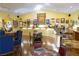 A welcoming interior with ample lighting, featuring artistic decor and multiple seating arrangements, ideal for relaxed entertaining at 3780 E Kellogg Rd, Pahrump, NV 89061