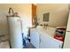 Convenient laundry area featuring a washing machine, dryer, and water heater at 3780 E Kellogg Rd, Pahrump, NV 89061