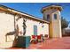 Outdoor seating area with a statue, table, and chairs, perfect for enjoying the winery's ambiance at 3780 E Kellogg Rd, Pahrump, NV 89061