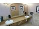 Clean restroom featuring dual sinks, framed artwork, and a large mirror above a stone-like countertop, adding elegance and functionality at 3780 E Kellogg Rd, Pahrump, NV 89061
