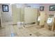 Public restroom with multiple stalls and urinals, featuring tile flooring and walls for cleanliness and durability at 3780 E Kellogg Rd, Pahrump, NV 89061