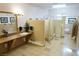 Commercial restroom features multiple stalls, tiled walls, a granite countertop, and flower accents at 3780 E Kellogg Rd, Pahrump, NV 89061