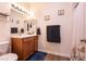 Bathroom with wood vanity, framed mirror, and decorative lighting at 425 Golden State St, Henderson, NV 89012