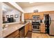 Traditional kitchen features stainless steel appliances, granite countertops, and wood cabinets at 425 Golden State St, Henderson, NV 89012