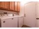 Well-lit laundry room featuring a side-by-side washer and dryer and upper cabinets for ample storage at 425 Golden State St, Henderson, NV 89012