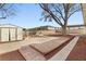 Spacious backyard featuring a storage shed and a large tree providing shade at 4404 Montebello Ave, Las Vegas, NV 89110