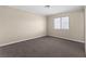 Large bedroom with neutral carpet, walls and baseboards and large window at 4404 Montebello Ave, Las Vegas, NV 89110