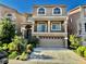 Inviting two-story home featuring a well-manicured front yard and a charming balcony above the garage at 4488 Mission Meadow Cir, Las Vegas, NV 89139