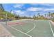 Well-maintained basketball court with vibrant colors, surrounded by greenery and a clear blue sky, great for recreation at 454 White Heart Rd, Las Vegas, NV 89148