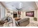 Open-concept living room with a fireplace, built-in shelving, and seamless flow to the dining area at 454 White Heart Rd, Las Vegas, NV 89148