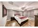 Comfortable main bedroom featuring wood floors, ceiling fan, and soft natural light at 454 White Heart Rd, Las Vegas, NV 89148