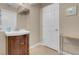 Bathroom with a dark wood vanity, sink, framed mirror, and a white paneled door at 4861 S Torrey Pines Dr # 201, Las Vegas, NV 89103