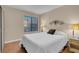 Bedroom featuring hardwood floors, queen bed and ample natural light at 4861 S Torrey Pines Dr # 201, Las Vegas, NV 89103
