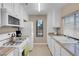 Bright kitchen features white cabinets, granite countertops, and modern appliances at 4861 S Torrey Pines Dr # 201, Las Vegas, NV 89103