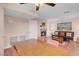 Open-concept dining and living area with fireplace, ceiling fan, hardwood floors, and comfortable seating at 4861 S Torrey Pines Dr # 201, Las Vegas, NV 89103