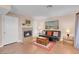 Cozy living room featuring hardwood floors, a fireplace with tiled surround, and comfortable seating at 4861 S Torrey Pines Dr # 201, Las Vegas, NV 89103