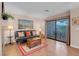 Comfortable living room with hardwood floors, a sofa, a sliding glass door to the outdoor patio at 4861 S Torrey Pines Dr # 201, Las Vegas, NV 89103