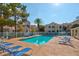 Community pool surrounded by lounge chairs and well-maintained landscaping at 4861 S Torrey Pines Dr # 201, Las Vegas, NV 89103
