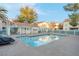Outdoor swimming pool surrounded by lounge chairs, trees, and condos at 4861 S Torrey Pines Dr # 201, Las Vegas, NV 89103