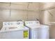 Bright laundry room with a washing machine, dryer, and shelving for storage at 5087 Midnight Oil Dr, Las Vegas, NV 89122