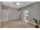 A bright bedroom features neutral walls and carpet with white trim and ceiling fan at 5250 S Rainbow Blvd # 2165, Las Vegas, NV 89118