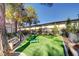Enclosed dog park with artificial turf, seating, and play equipment for pets to enjoy at 5250 S Rainbow Blvd # 2165, Las Vegas, NV 89118